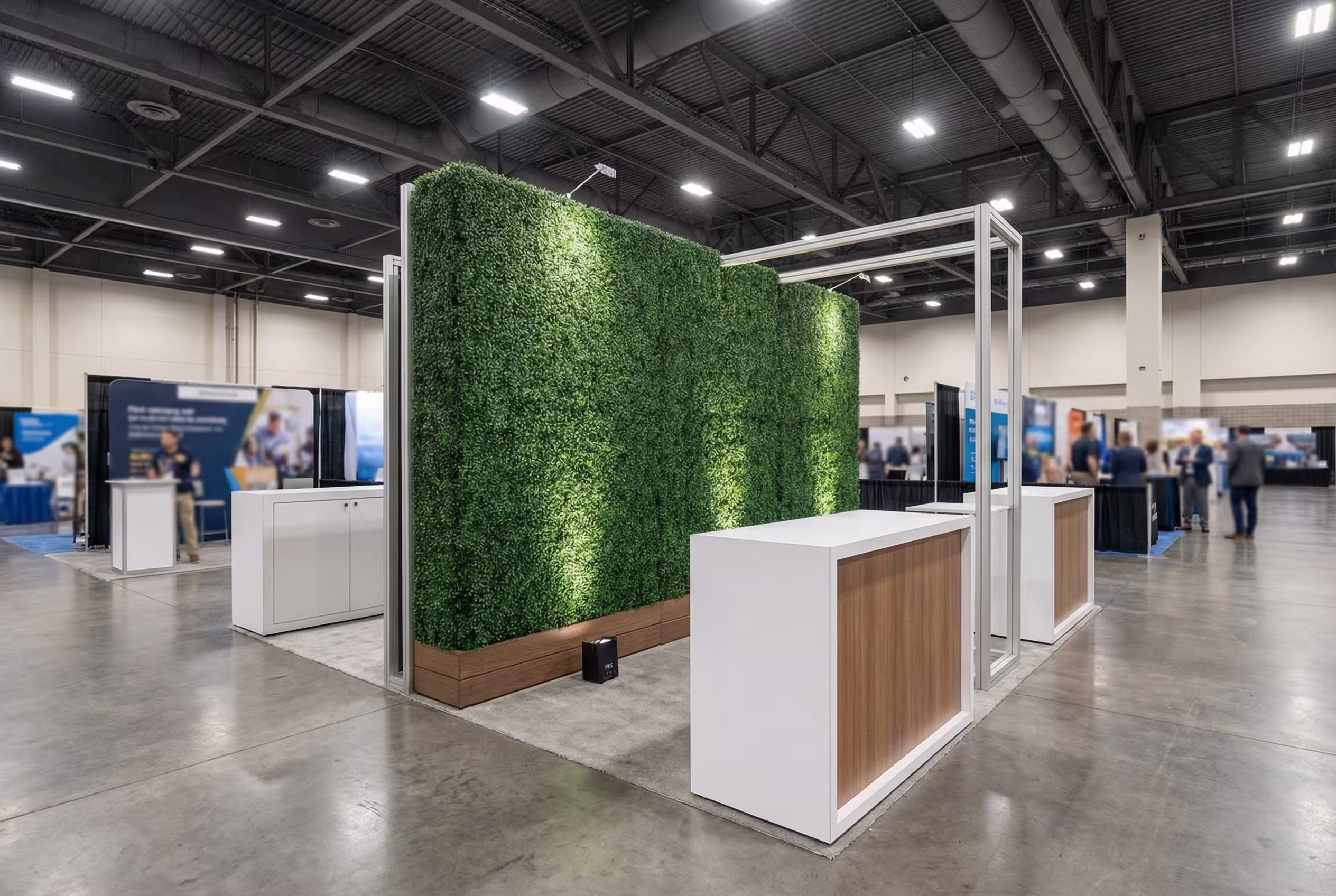 Custom boxwood hedge booth walls creating a branded trade show exhibit space